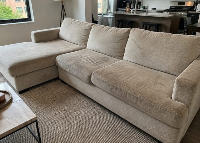 Stained fabric sofa before professional upholstery cleaning in a Melbourne home